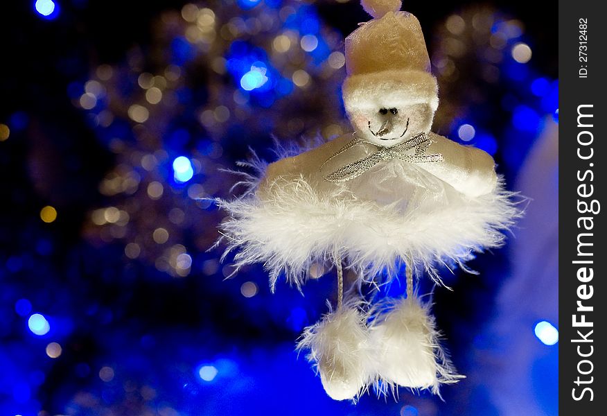 On a blue background with a large white lights Christmas Toy. On a blue background with a large white lights Christmas Toy