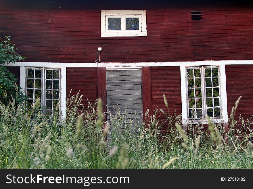 Old abandoned building in red hardwood and white windows. Old abandoned building in red hardwood and white windows