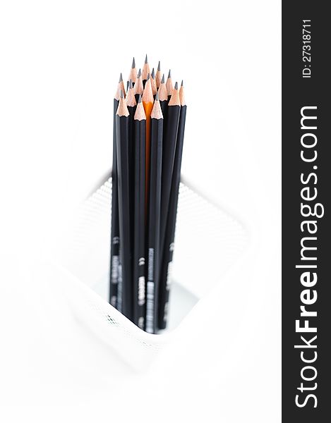 Pencils in the meshy box on white background