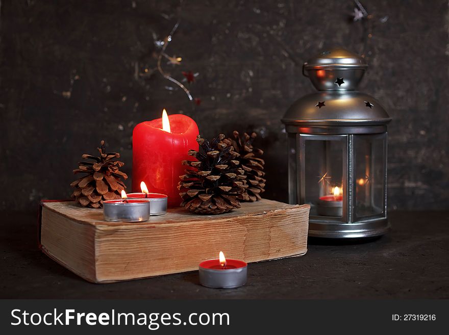 Christmas decoration with candles and old book
