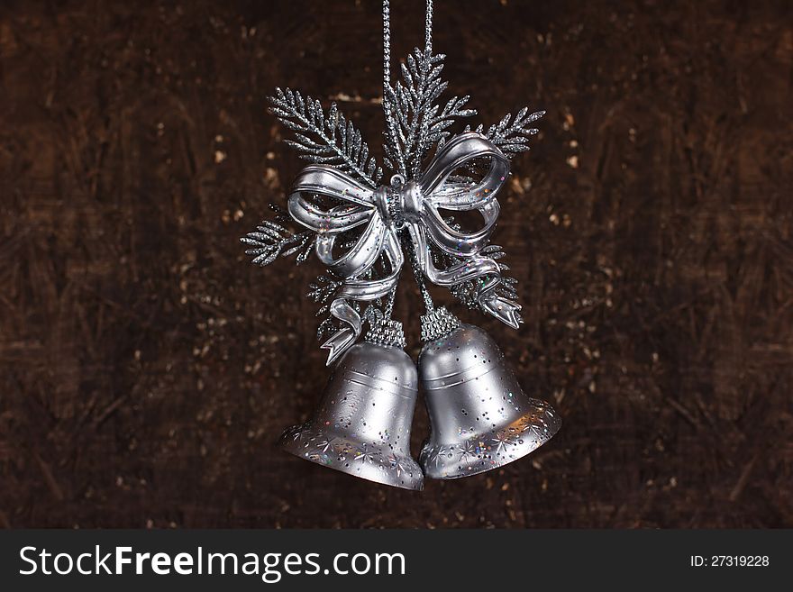 Christmas decoration with silver bells with wooden background. Christmas decoration with silver bells with wooden background