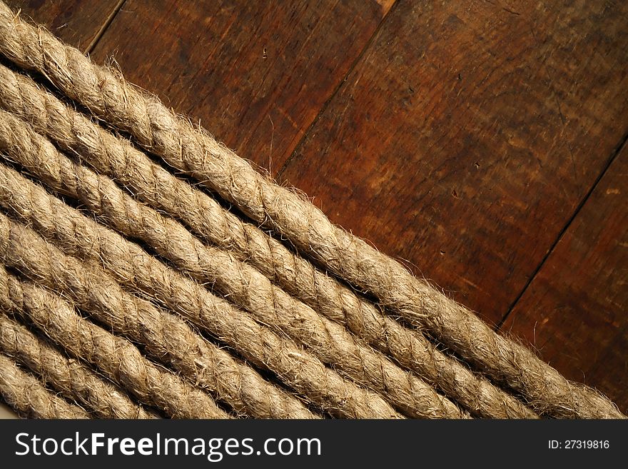 Old hemp rope on dark wooden surface. Old hemp rope on dark wooden surface