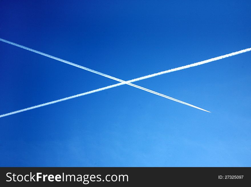 White crossing trace of airplanes in blue sky. White crossing trace of airplanes in blue sky