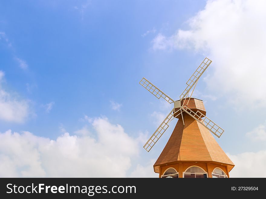 Dutch style windmill in blue sky and white cloud