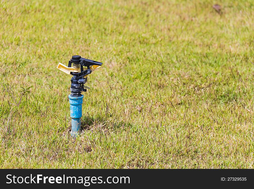 Unused automatic sprinkler head of watering system on the lawn