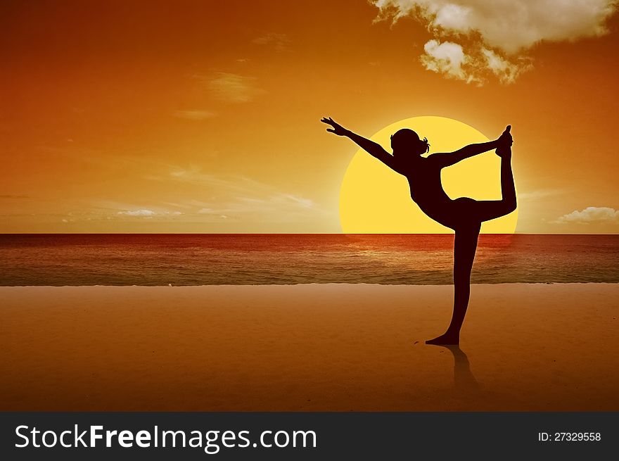 A girl is doing yoga on the beach.