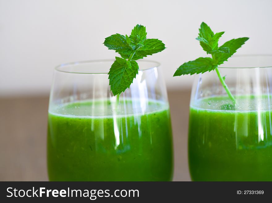Healthy wheatgrass juice with orange and mint
