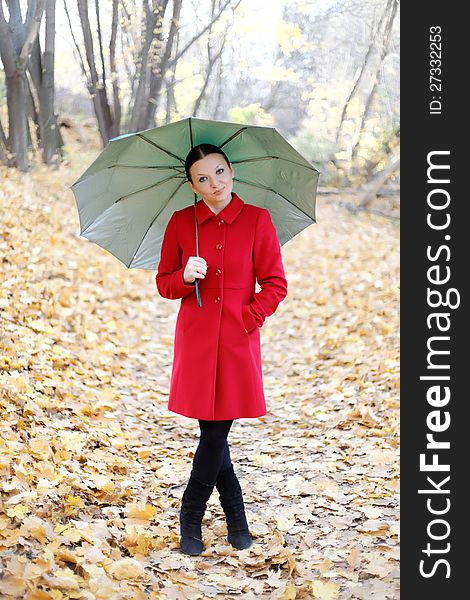 Cute Girl In The Autumn Forest With Umbrella