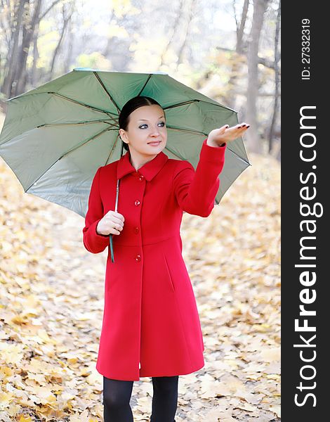 Girl in the autumn forest with umbrella