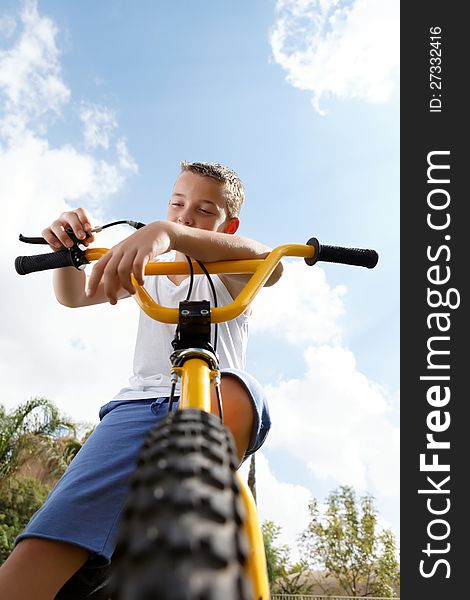 Pretty boy on a bicycle outside