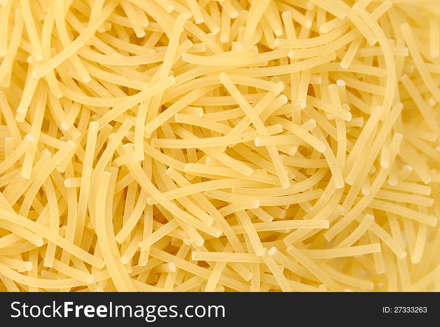 A close-up of short cut vermicelli (fideo) pasta as a background. A close-up of short cut vermicelli (fideo) pasta as a background