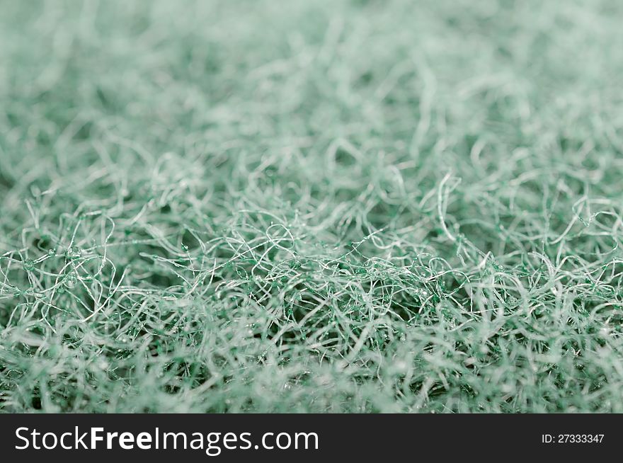 A super macro shot of green scrubbing sponge texture. A super macro shot of green scrubbing sponge texture