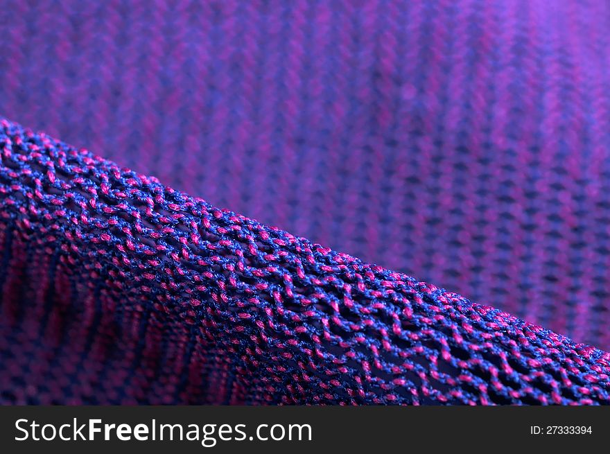 A super macro shot of pink and purple fabric texture. A super macro shot of pink and purple fabric texture