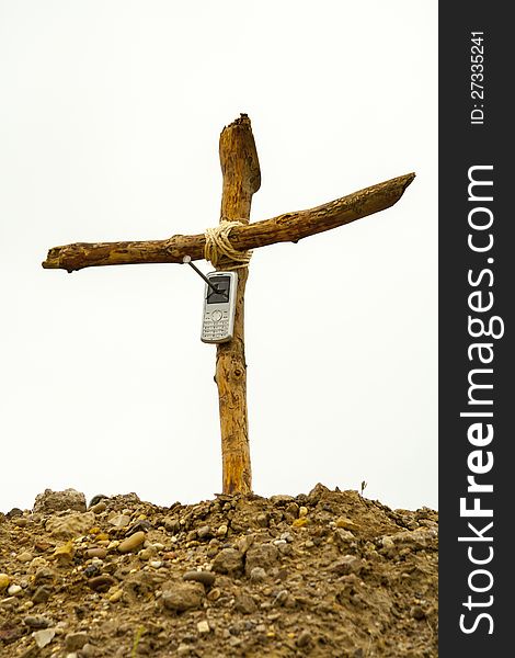 Cell Phone On Wooden Cross