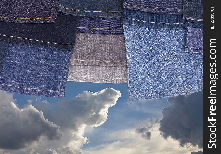 Hanging leg jeans are superimposed on a background of the cloudy sky with. Hanging leg jeans are superimposed on a background of the cloudy sky with.