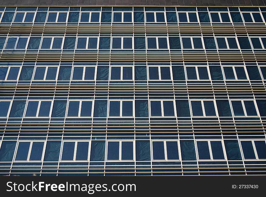 A large number of identical windows on a building wall