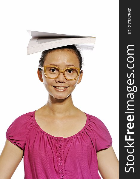 Asian college woman put book on her head isolated over white background. Asian college woman put book on her head isolated over white background