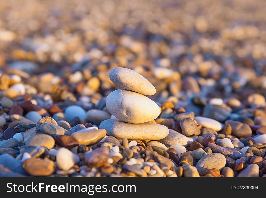 Three beach-stone pyramid in the morning sun. Three beach-stone pyramid in the morning sun