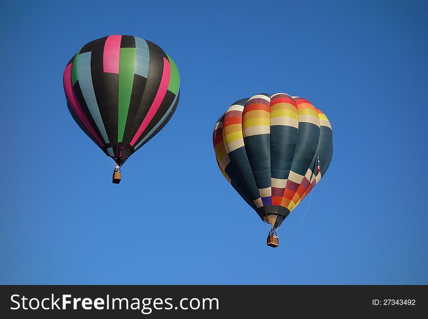 Square patterned hot air balloons, blue sky