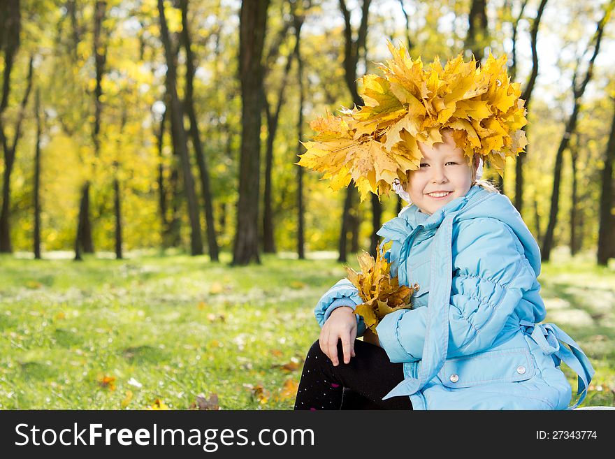 Little Girl Wearing A Crown Of Autumn Leaves