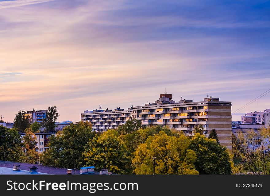 Buildings in a city in an environment of green trees. Buildings in a city in an environment of green trees