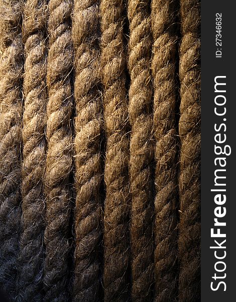 Extreme closeup of old rope background under beam of light