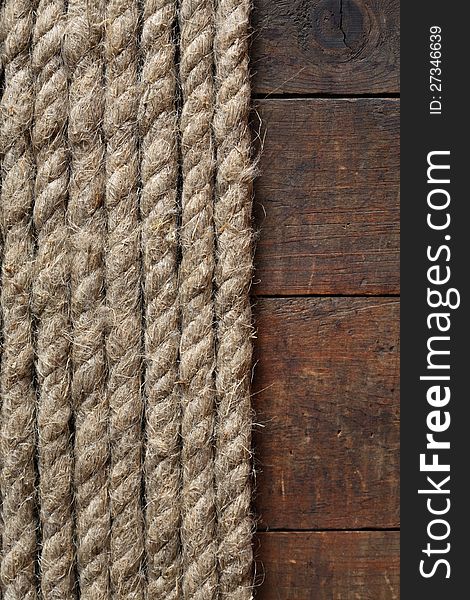 Old hemp rope on dark wooden surface. Old hemp rope on dark wooden surface