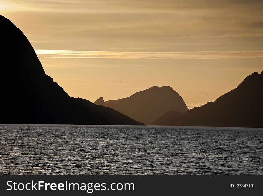 Sunset and mountain silhouette from the sea