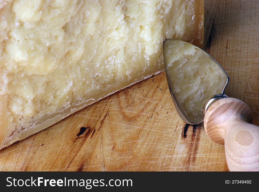 Pecorino cheese with knife over wooden chopping