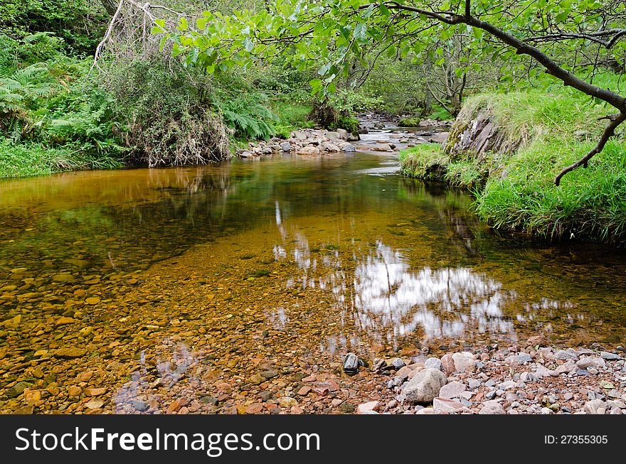 A slow pool in a rocky mountain stream. A slow pool in a rocky mountain stream