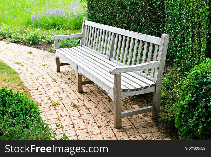 Wooden bench in a beautiful park garden. Wooden bench in a beautiful park garden