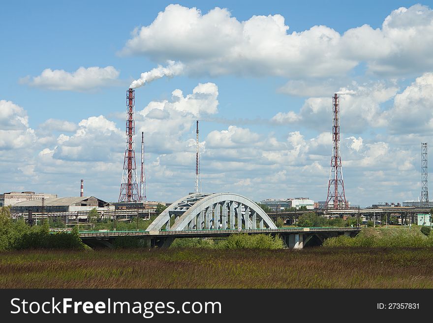 Pollutions of chemical plant pipes on blue sky with clouds background