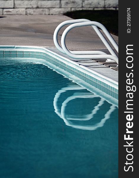 Swimming pool railing and reflection in water. Swimming pool railing and reflection in water