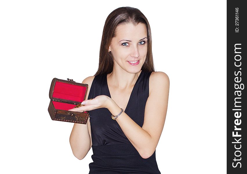 The beautiful young woman puts coins in a small, antiquarian chest. Separately on a white background. The beautiful young woman puts coins in a small, antiquarian chest. Separately on a white background