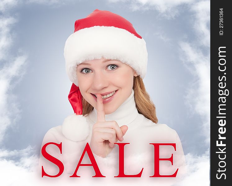 Christmas Sale and happy young woman in a Santa hat