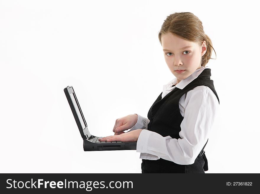 Girl with the computer in the school dress. Girl with the computer in the school dress