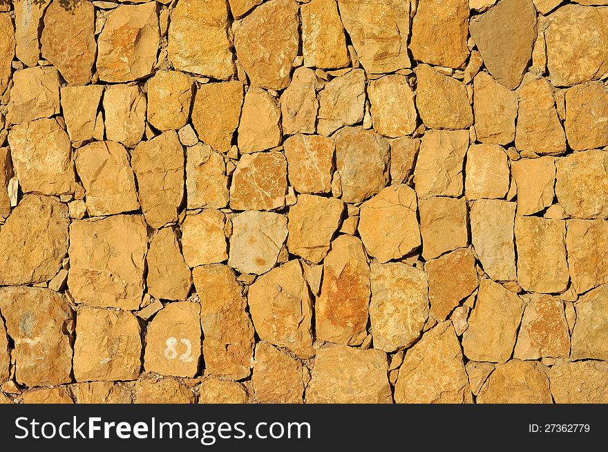 Wall made up by tiles of irregularly shaped stones. Wall made up by tiles of irregularly shaped stones