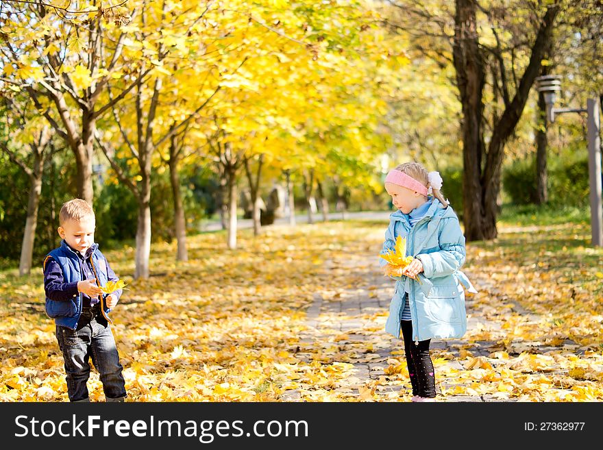 Children In A Colourful Autumn Park