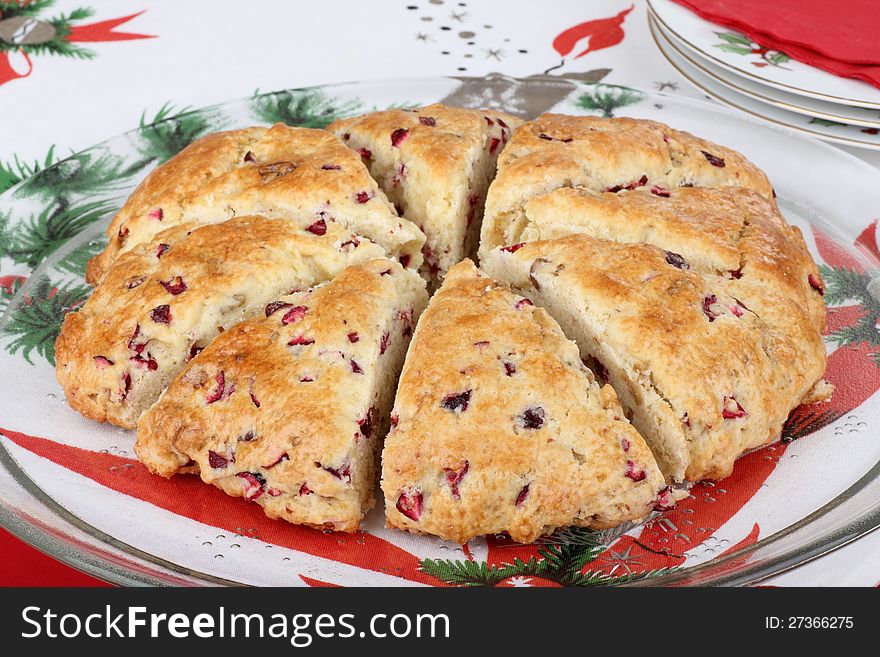 Sliced cranberry nut scone on a glass platter. Sliced cranberry nut scone on a glass platter