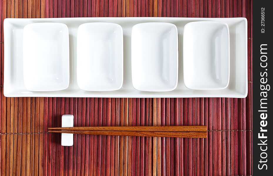 Chopsticks and plate mat  in asian set table. Chopsticks and plate mat  in asian set table