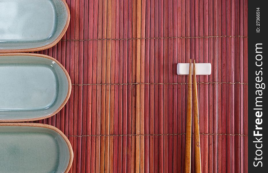 Chopsticks and plate mat  in asian set table. Chopsticks and plate mat  in asian set table