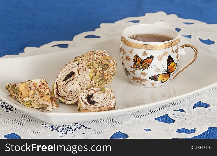 Food Turkish delight and cup of tea on blue napkin