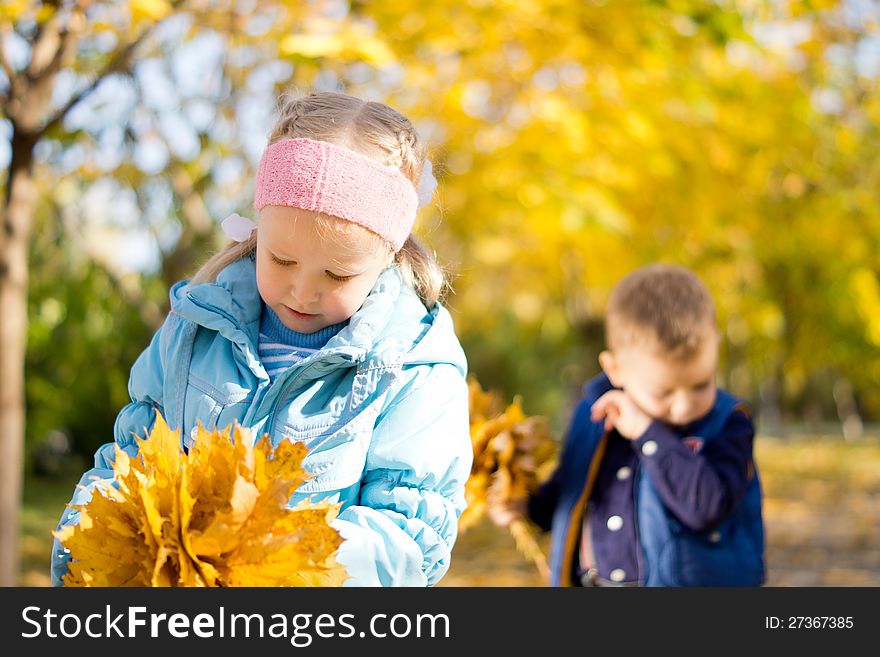 Children In The Park In An Autumn Day