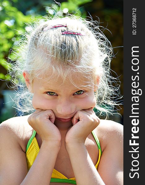 Portrait of serious little girl outdoors