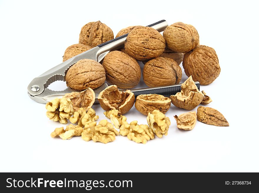 The walnut with nutcracker on the white background
