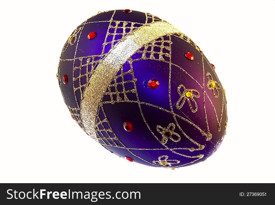 Christmas decoration in the shape of a large egg. Basis of purple with a pattern of golden threads and golden ribbon, with yellow and ruby red rhinestones. Christmas decoration in the shape of a large egg. Basis of purple with a pattern of golden threads and golden ribbon, with yellow and ruby red rhinestones.