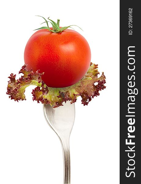 The fresh tomato on fork