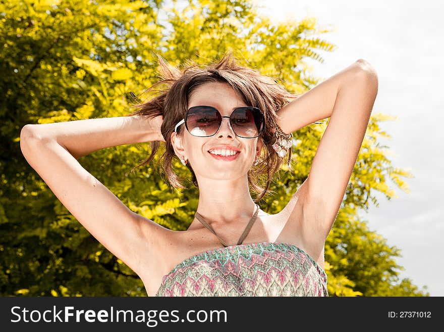 Beautiful sexy woman portrait to the nature in black sunglasses. Beautiful sexy woman portrait to the nature in black sunglasses