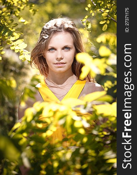 Very beautiful girl in a yellow dress on the nature