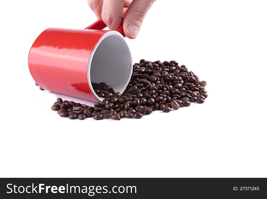 Coffee cup on roasted coffee beans on white